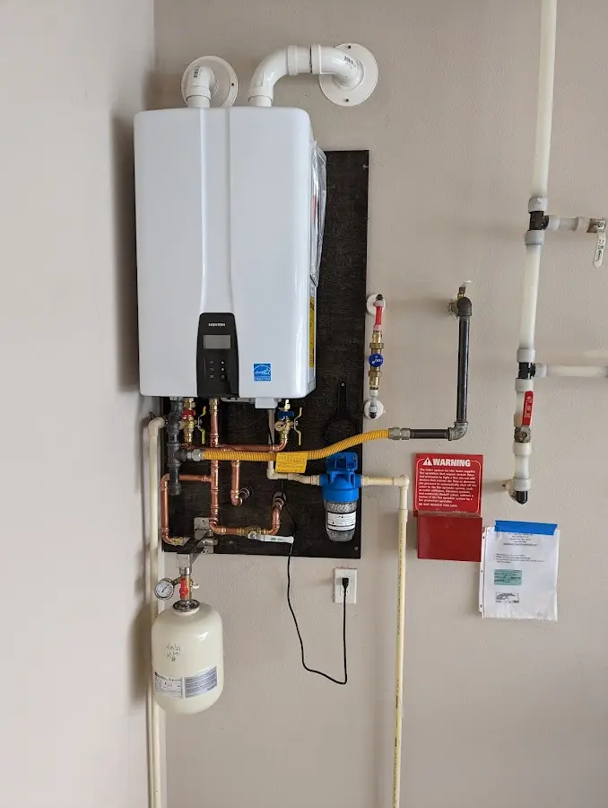 Professional plumber installing copper piping in a Candor home